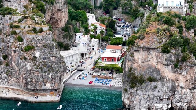 Aerial 4K drone video footage with panorama of Marina di Praia and Praiano coastline, scenic Amalfi Coast landscape with Mediterranean seaside views in Italy
