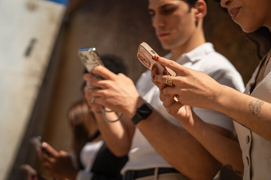 Young people immersed in smart phones communicating and connecting online
