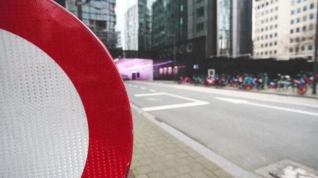 No Entry Road Sign Prohibits Traffic On The City Street With A Road And Modern Buildings In The Background