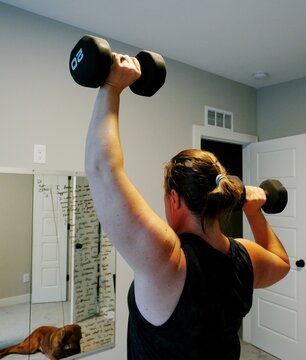 Woman Doing Video Workout in Home Gym - Home Fitness Exercise Weightlifting Healthy Lifestyle Building Muscle Daily to Age Gracefully