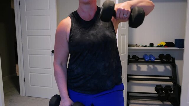 Woman Doing Video Workout in Home Gym - Home Fitness Exercise Weightlifting Healthy Lifestyle Building Muscle Daily to Age Gracefully