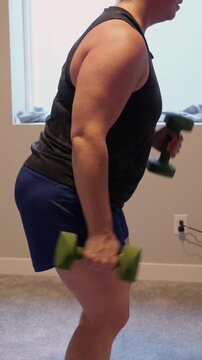 Woman Doing Video Workout in Home Gym - Home Fitness Exercise Weightlifting Healthy Lifestyle Building Muscle Daily to Age Gracefully