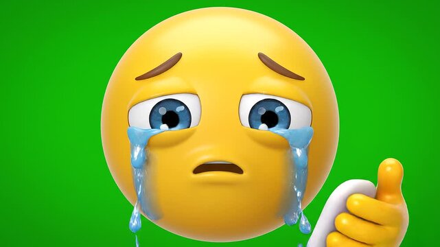 Crying yellow emoji character wiping away tears with a tissue on green background