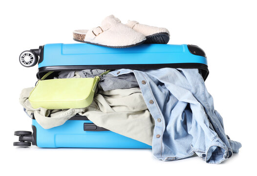 Suitcase with packed stuff isolated on white