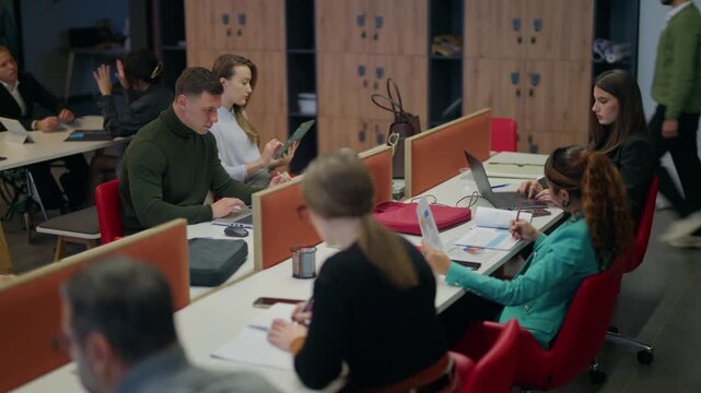 Professionals engage in focused work and discussions within a contemporary office setting. Employees actively contribute to projects and collaborate on daily tasks.