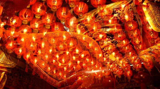 Chinese deities and red lanterns in temple during Lunar New Year