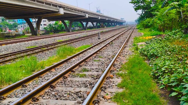 Wide Railway Tracks Perspective View Under Overpass Bridge in Bangladesh Transport Infrastructure Scene