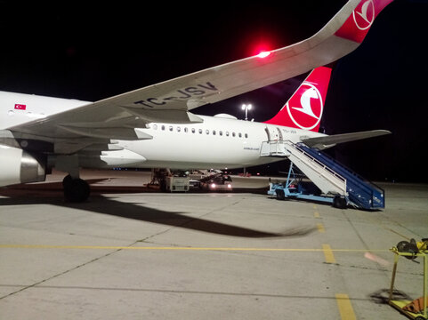 Varna. Bulgaria. 25.05.2026  Turkish Airlines Airbus A321 aircraft at night on airport apron with red tail logo and boarding stairs. Aviation travel concept