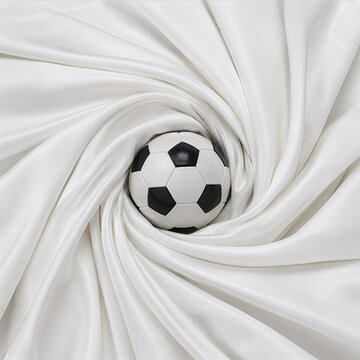 Soccer Ball Nestled inside Clean White Satin Silk Swirl Background
