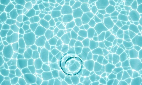 Top-down view of rippling clear turquoise water over white sand with caustic light patterns and organic movement