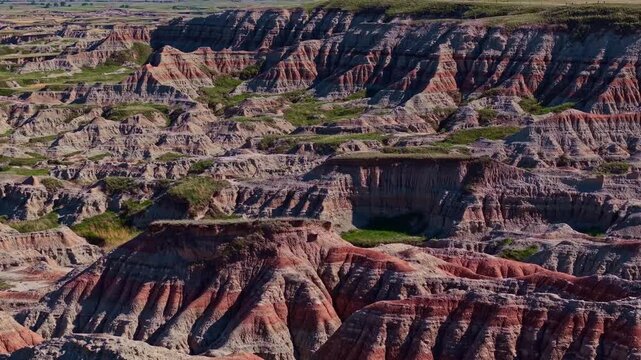 Aerial view of dramatic eroded colorful rock formations and badlands terrain near Badlands National Park, South Dakota
