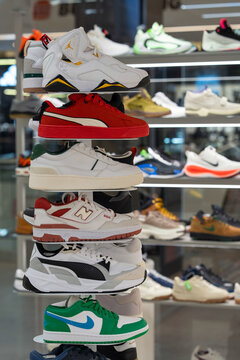 Sports shoes are sold in store. Sneakers of various brands on store shelves - Nike, Air Jordan, Puma, New Balance, Lacoste. Wide selection of athletic shoes in store. Minsk, Belarus - March 30, 2026