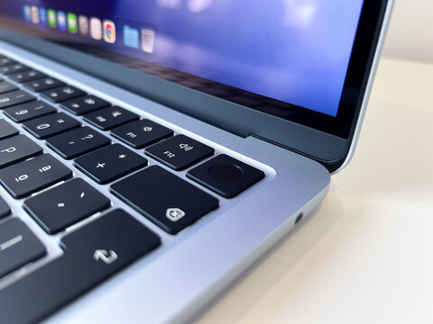 Touch ID fingerprint sensor on an Apple MacBook Air M5 laptop computer. Close up.