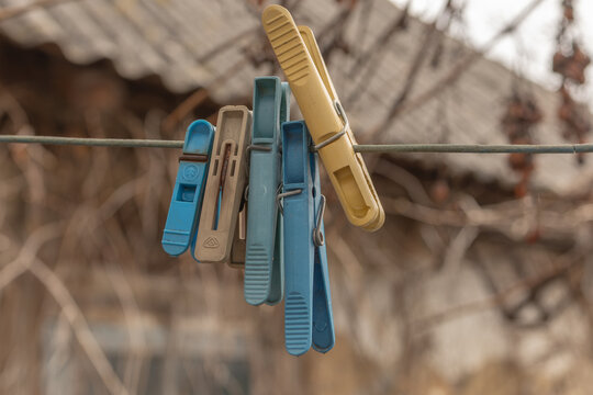 a bunch of clothes pegs hanging on a clothesline