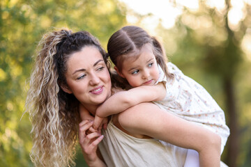 Fototapeta premium Mother with her cute little daughter in nature