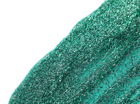 Green glitter nail polish on white background, top view