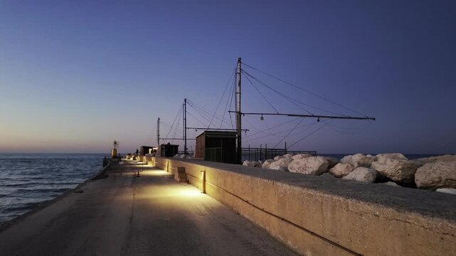 Senigallia pier at sunset with typical italian fishing houses called "trabucchi". - Marche region, Italy