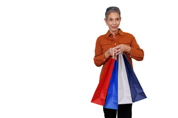 Obraz premium Senior woman enjoying retail therapy, holding colorful shopping bags after successful purchase on transparent background