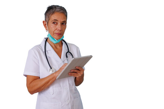 Female doctor with medical mask pulled down, holding a digital tablet and typing, presenting healthcare technology. Transparent background
