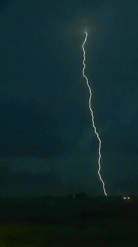 lightning strikes flashing against a dramatic dark cloudy storm sky