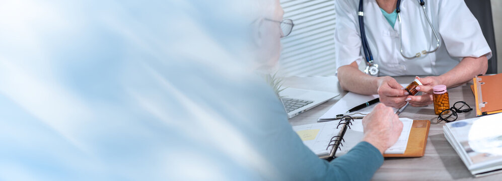 Female doctor explaining medicine to her patient; panoramic banner