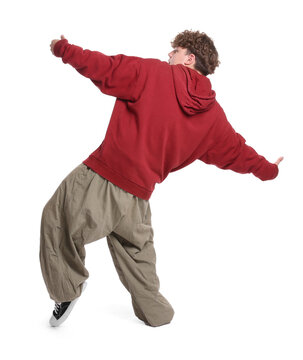 Young man performing hip-hop dance on white background, back view