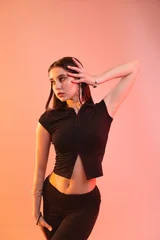 Fototapeten Tanzen Young hip-hop dancer in stylish clothes posing on color background  © New Africa