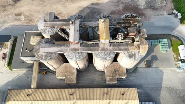 Aerial view of industrial silos and storage facility showcasing the continuous layout of cylindrical structures and surrounding elements in a commercial setting