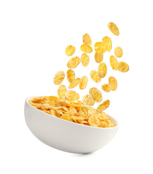 Corn flakes and bowl in air against white background