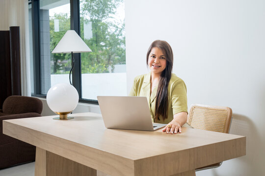 Professional Woman Working on Laptop in Modern Office Interior