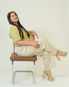 Happy Woman Sitting on Chair on White Background