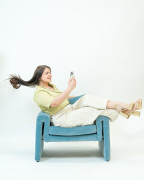 Relaxed Woman Taking Selfie in Minimal Studio Portrait