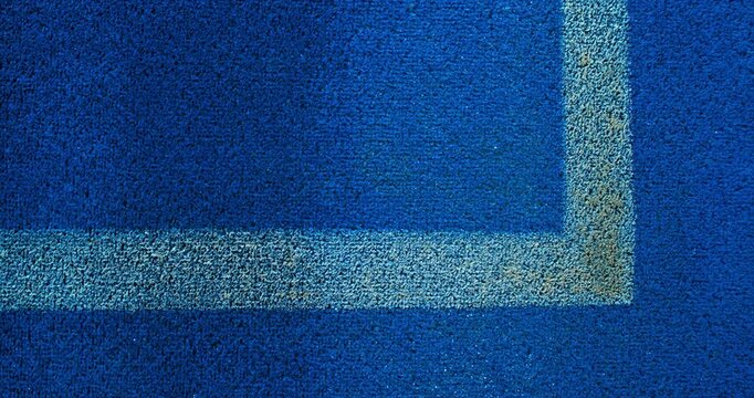Extreme super slow motion close-up of a tennis or padel ball bouncing near the court line. Detailed blue surface texture captured at 1000fps with dynamic sports action in macro detail.