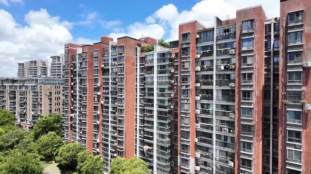 Modern high-rise apartment buildings with balconies in a Chinese urban neighborhood. Dense contemporary housing development, and residential blocks. City living in Ningbo, China.