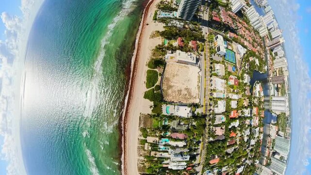 Aerial traverse from residential homes to highrise condos on the beach fisheye aerial 4k