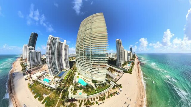 Drone rising up next to highrise condo buildings on the beach 4k 60p
