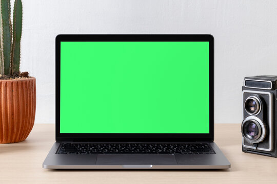 Laptop with green screen display, suitable as mockup