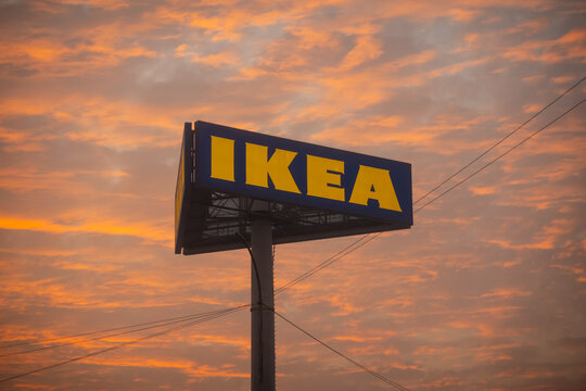 IKEA sign against a dramatic sunset sky at twilight