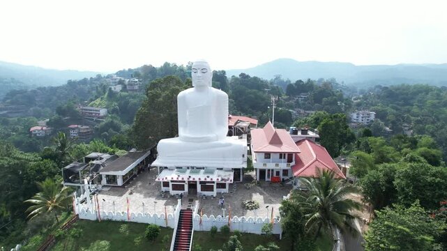 Aerial drone footage of the great Buddha Sri Maha Bodhi Viharaya in the city of Kandy, Sri Lanka, on a sunny day, 4k 30fps, 1 inch sensor