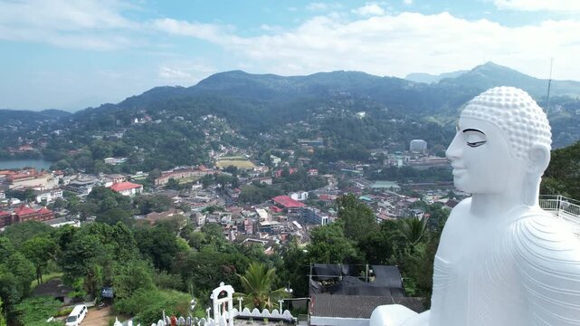 Aerial drone footage of the great Buddha Sri Maha Bodhi Viharaya in the city of Kandy, Sri Lanka, on a sunny day, 4k 30fps, 1 inch sensor