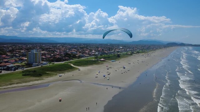 Powered Paraglider Flying Along a Tropical Beach