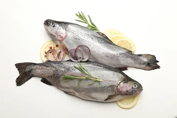 Raw trout fish and spices on white table, flat lay © New Africa
