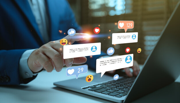 Businessman using laptop with social media engagement interface, online customer communication and digital marketing notifications for audience interaction and brand promotion.