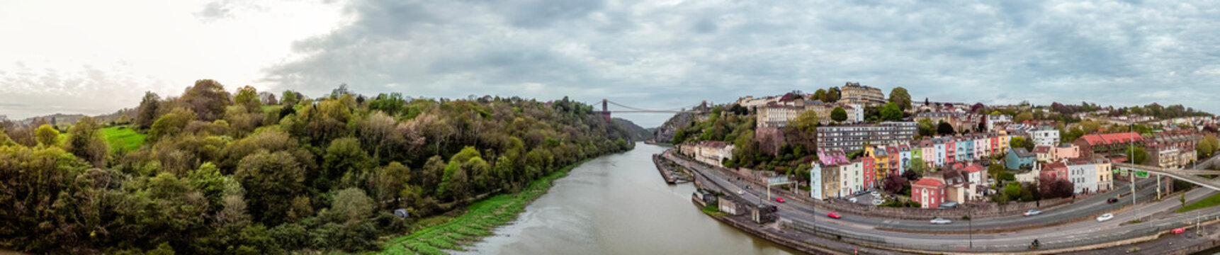 This panoramic image captures the Clifton Suspension Bridge spanning the Avon Gorge in Bristol, England, connecting Clifton to Leigh Woods.