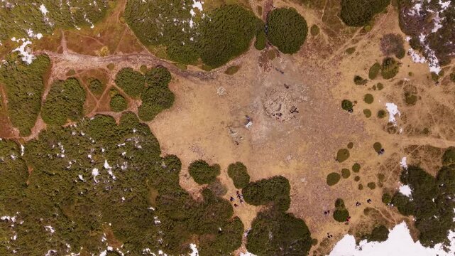 Aerial drone view of Pilsko mountain summit with hikers and snow patches