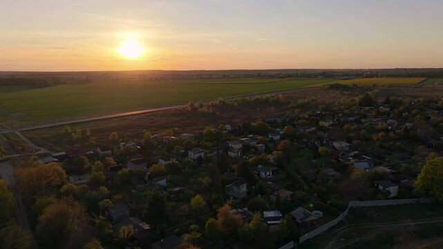 Aerial drone view of recreational garden plots with small cottages and greenery