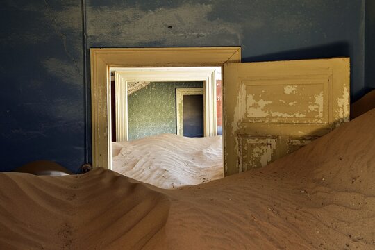 Desert sand in the ruined building of the former diamond city, ghost town, Kolmanskop, L&uuml;deritz, Namibia