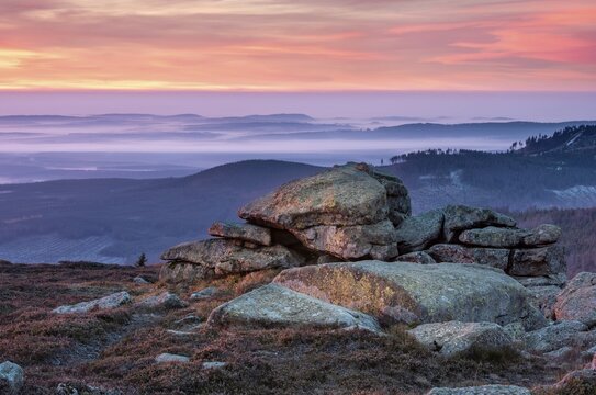Sunrise on the Brocken, view over hills and forests with valley fog, in front the devil's pulpit, Harz National Park, Saxony-Anhalt, Germany