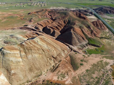 Aerial view of a hilly landscape with striking rock formations and a road in the background, aerial view, mountains on D70 and D80, Tuzluca, Igdir province, Iğdır, Eastern Anatolia, Anatolia, Turkey