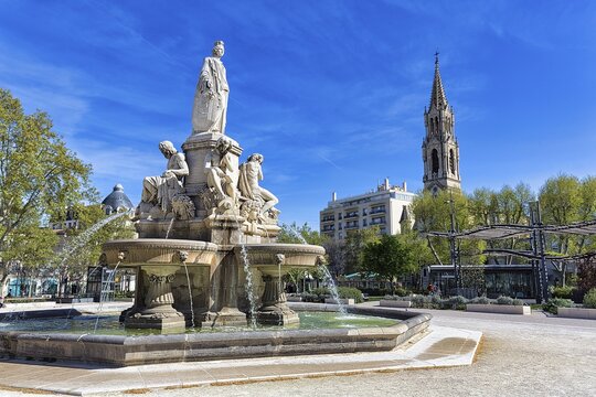 Fontaine Pradier, large fountain in the square Esplanade Charles-de-Gaulle, bell tower of the church Sainte-Perp&eacute;tue and Sainte-F&eacute;licit&eacute;, N&icirc;mes, Languedoc-Roussillon, France